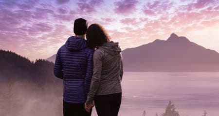 Man and Woman Standing Together Holding hands enjoying the beautiful landscape view. Pink cloudy sunset art render. Background from Howe Sound near Vancouver, BC, Canada. Love, Relationship Concept.